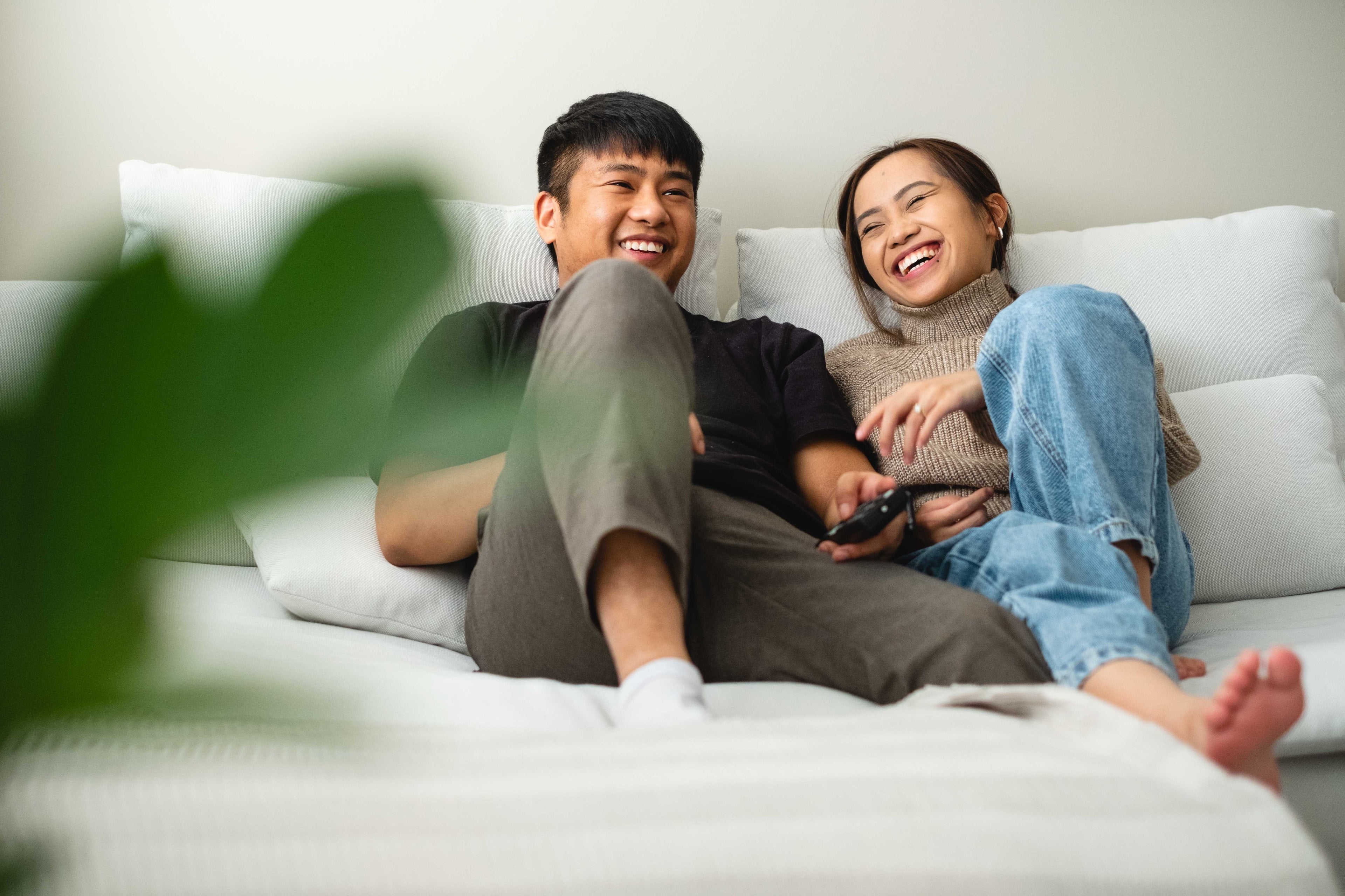 couple laughing on couch